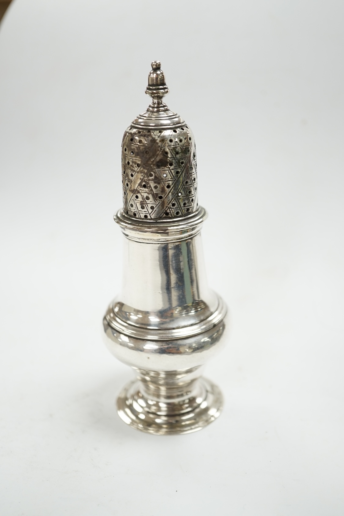 A George III silver baluster pepperette, John Delmester, London, 1763, 14.1cm. Condition - poor to fair